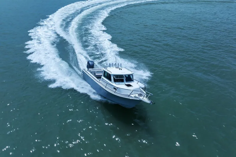 Slide: The Image of Parker 2320 Sport Cabin 2024 cruising swiftly on water. - 16