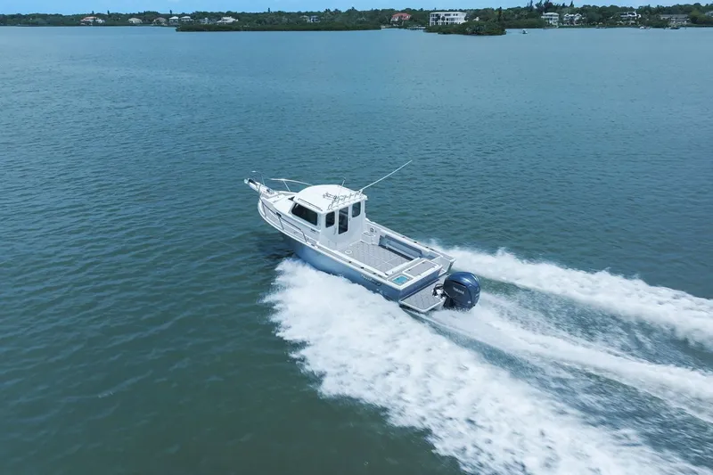 Slide: The Image of 2024 Parker 2320 Sport Cabin cruising on calm waters. - 17