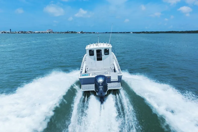 Slide: The Image of Parker 2320 Sport Cabin 2024 on open water, rear view. - 18