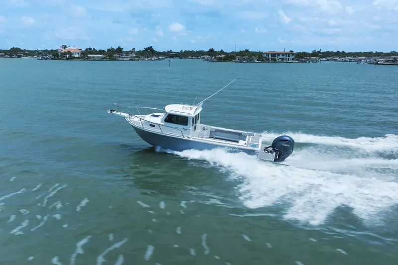 Slide: The Image of Parker 2320 Sport Cabin 2024 cruising swiftly on the water. - 20