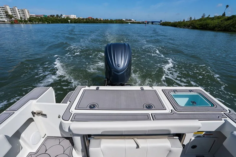 Slide: The Image of Rear view of 2024 Parker 2320 Sport Cabin on the water. - 21