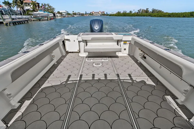 Slide: The Image of Parker 2320 Sport Cabin 2024 on calm waters with stylish deck. - 33