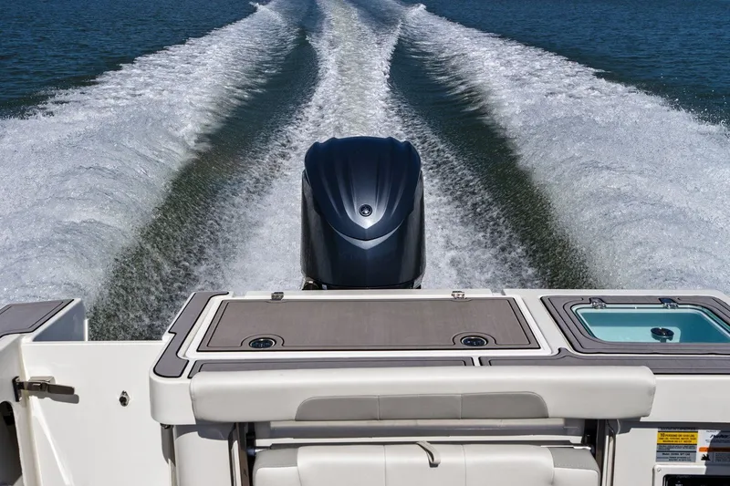 Slide: The Image of Parker 2320 Sport Cabin 2024 on water with engine wake. - 36