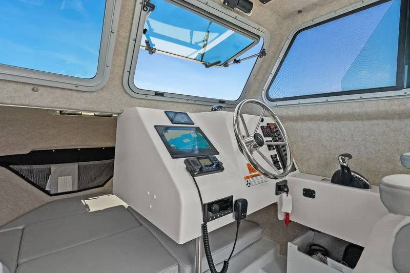 Slide: The Image of Interior of 2024 Parker 2320 Sport Cabin with steering console. - 43