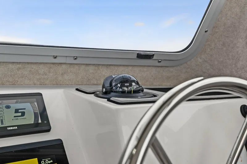 Slide: The Image of Interior view of 2024 Parker 2320 Sport Cabin with compass and steering wheel. - 48