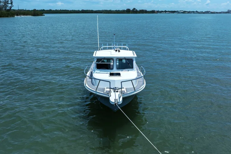 Slide: The Image of Parker 2320 Sport Cabin 2024 on calm waters. - 5