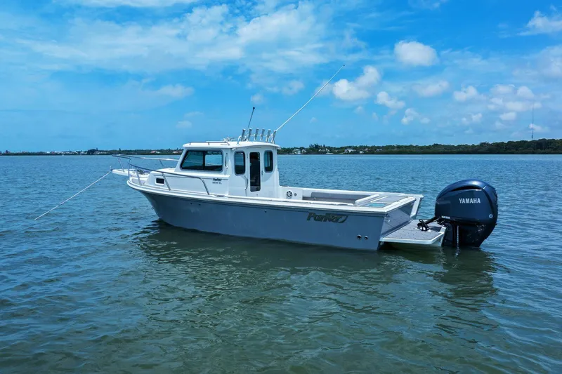 Slide: The Image of Parker 2320 Sport Cabin 2024 on calm water with Yamaha engine. - 7