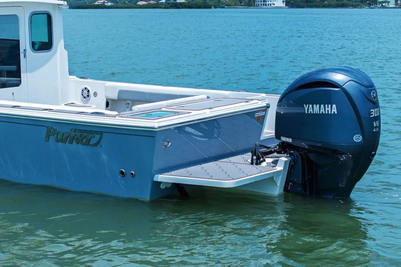 Slide: The Image of Parker 2320 Sport Cabin 2024 with Yamaha outboard motor on calm water. - 8
