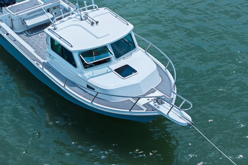 Slide: The Image of Parker 2320 Sport Cabin 2024 on calm water. - 9