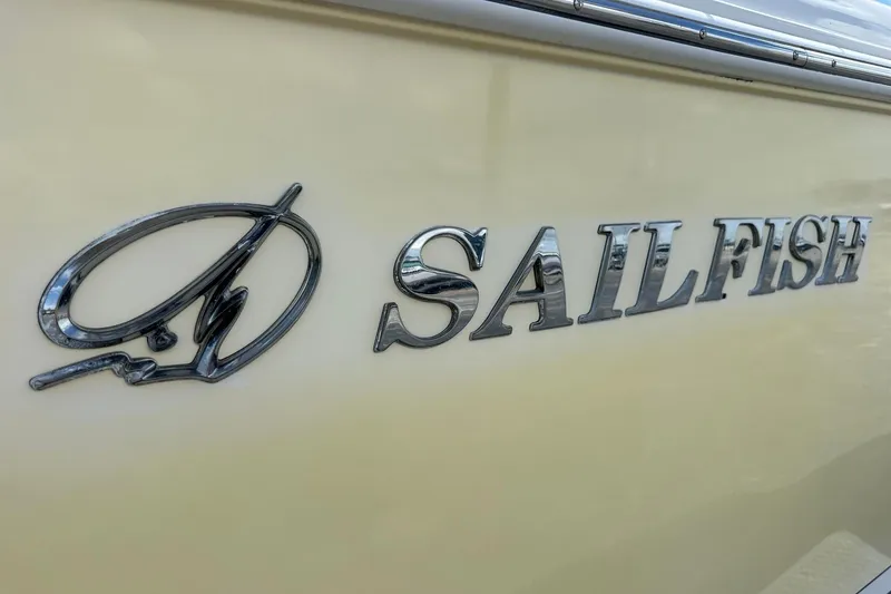 Slide: The Image of Close-up of 2015 Sailfish 275 DC boat logo on beige hull. - 8