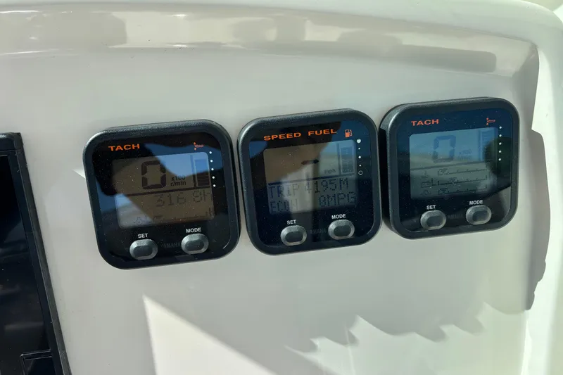 Slide: The Image of Digital gauges on a 2015 Sailfish 275 DC boat dashboard displaying tachometer and speed fuel data. - 10