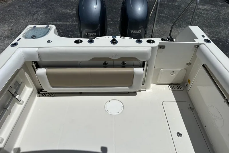 Slide: The Image of 2015 Sailfish 275 DC boat deck with Yamaha 150 engines, featuring seating and storage compartments. - 34