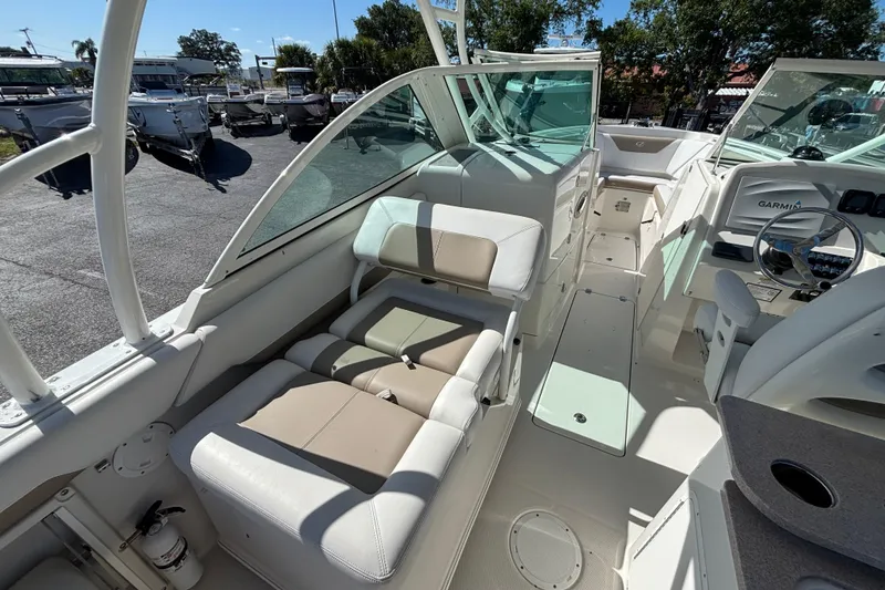 Slide: The Image of 2015 Sailfish 275 DC boat interior with seating and navigation equipment. - 12