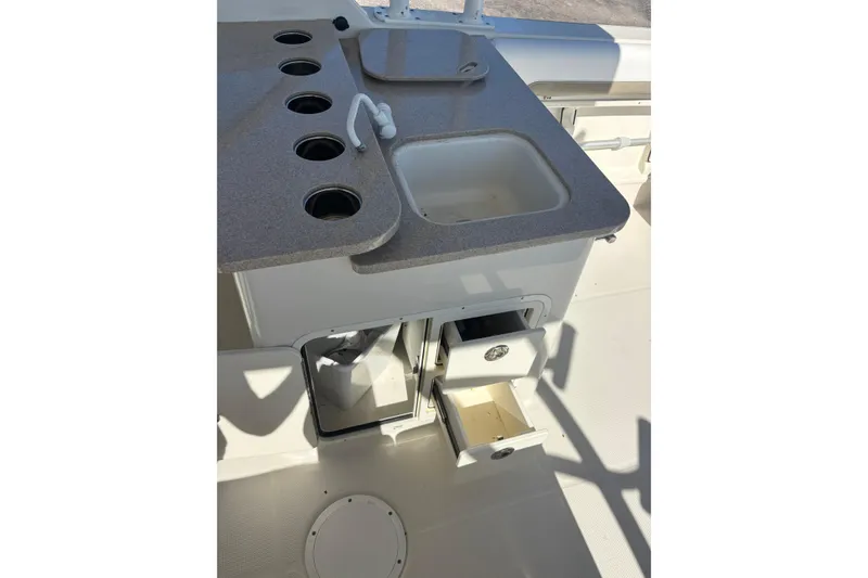 Slide: The Image of Interior view of 2015 Sailfish 275 DC boat with sink and storage drawers. - 13