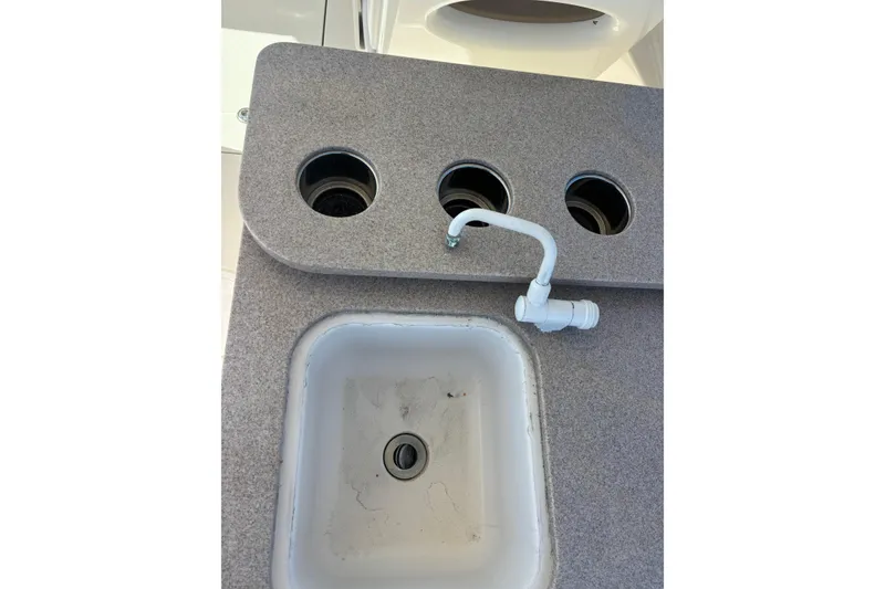 Slide: The Image of 2015 Sailfish 275 DC boat sink with faucet and cup holders. - 14