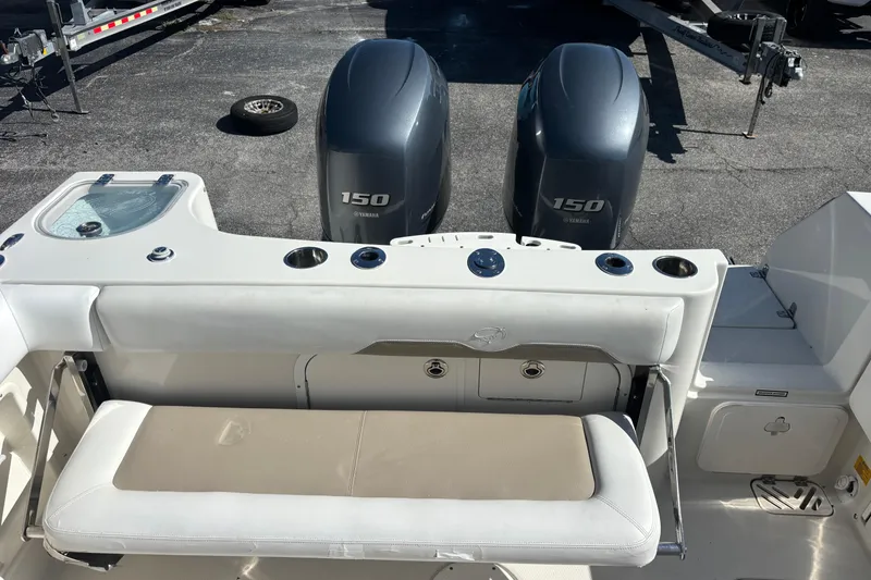 Slide: The Image of 2015 Sailfish 275 DC boat with dual Yamaha 150 engines and seating area. - 15