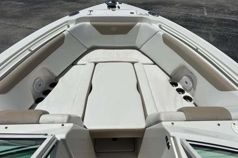 Slide: The Image of 2015 Sailfish 275 DC boat interior with cushioned seating and cup holders. - 12