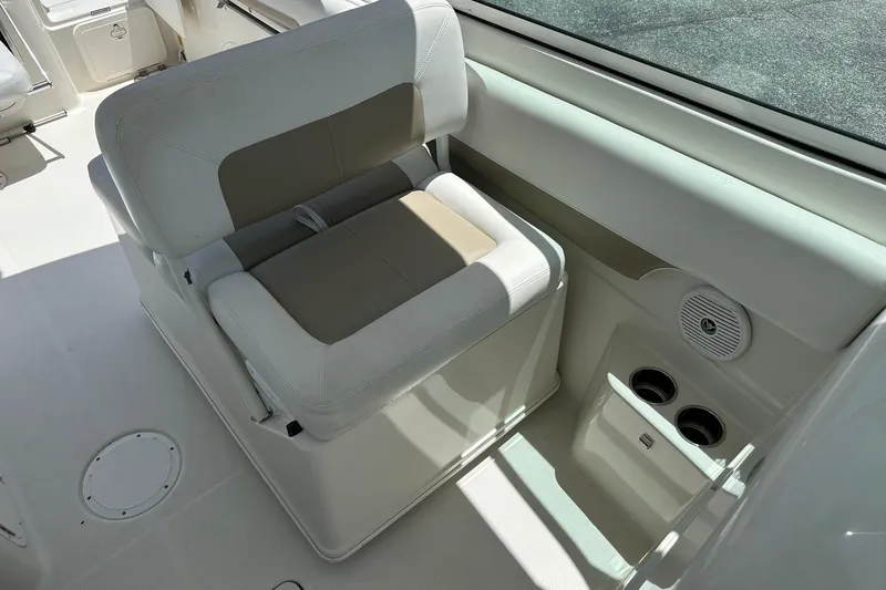 Slide: The Image of 2015 Sailfish 275 DC boat interior with cushioned seating and cup holders. - 19