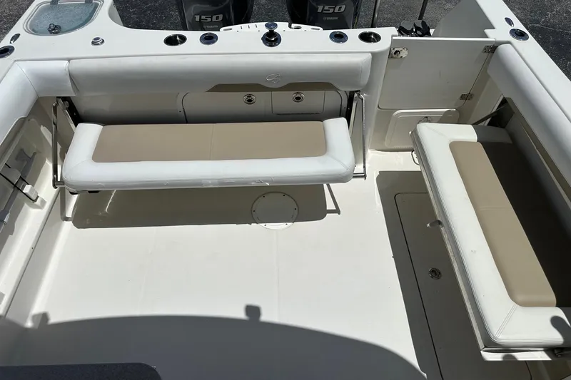 Slide: The Image of 2015 Sailfish 275 DC boat interior with cushioned seating and Yamaha 150 engines. - 33
