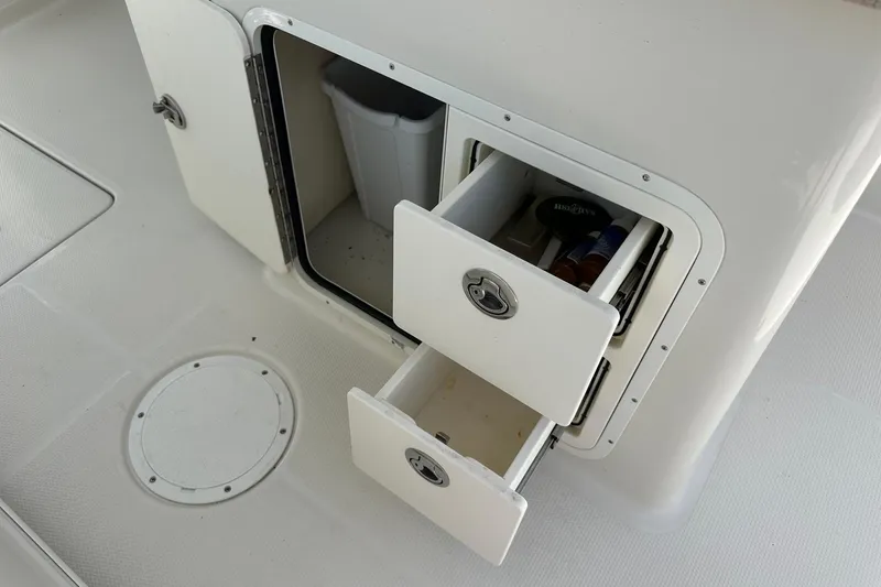 Slide: The Image of Storage compartment with drawers on a 2015 Sailfish 275 DC boat interior. - 30
