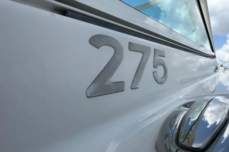 Slide: The Image of Close-up of 2015 Sailfish 275 DC boat model number on white hull. - 9