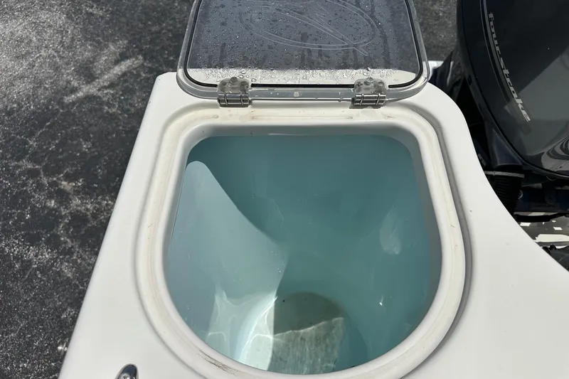 Slide: The Image of Open livewell on 2015 Sailfish 275 DC boat, showing interior and lid. - 38