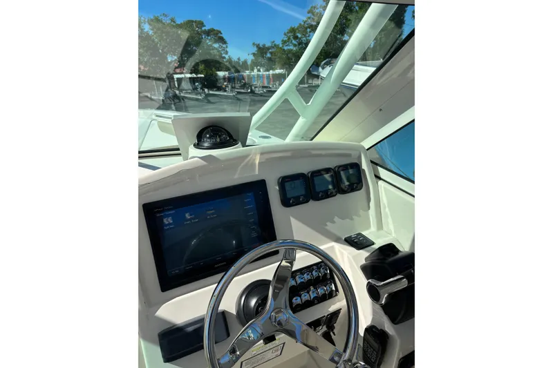 Slide: The Image of Helm of 2015 Sailfish 275 DC boat with modern navigation instruments and steering wheel. - 8
