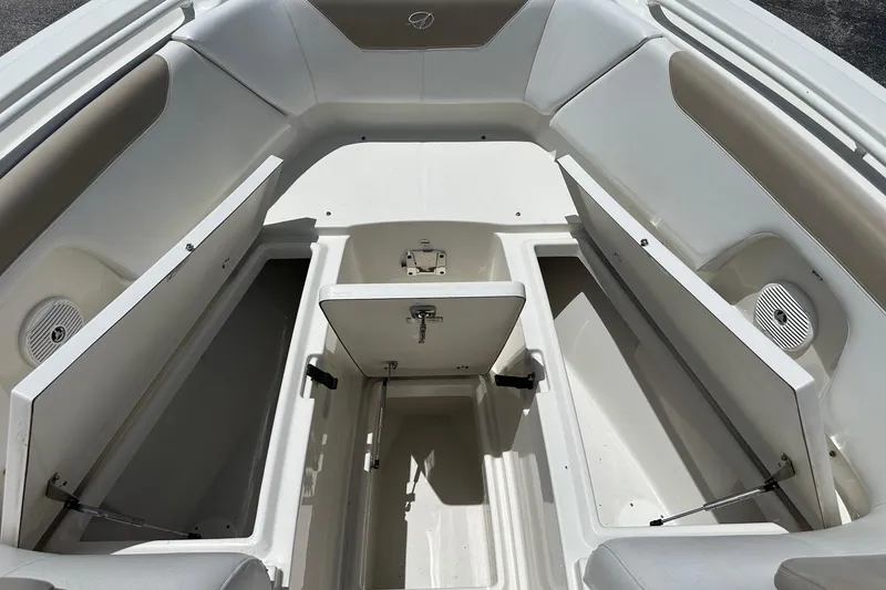 Slide: The Image of 2015 Sailfish 275 DC boat interior with open storage compartments and seating. - 16