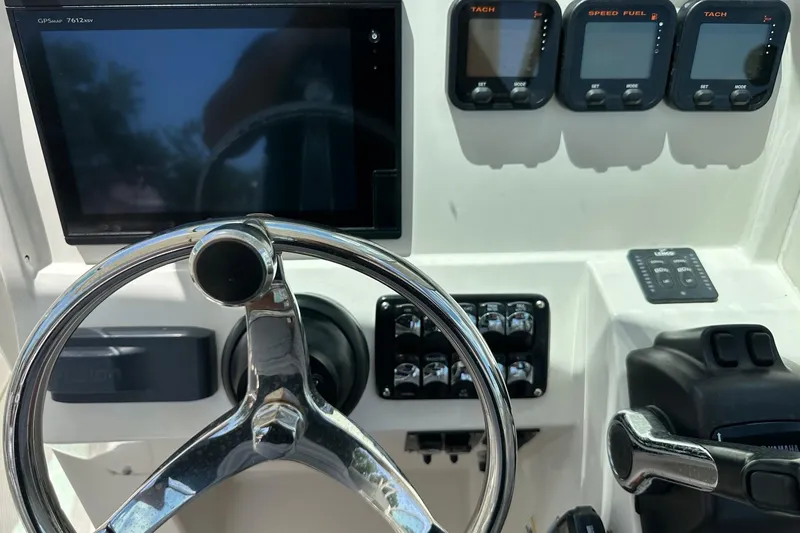 Slide: The Image of Steering console of a 2015 Sailfish 275 DC boat with gauges and controls. - 26