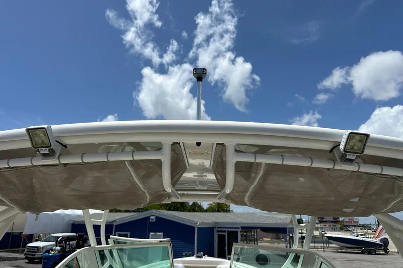 Slide: The Image of 2015 Sailfish 275 DC boat canopy under a clear blue sky with clouds. - 43