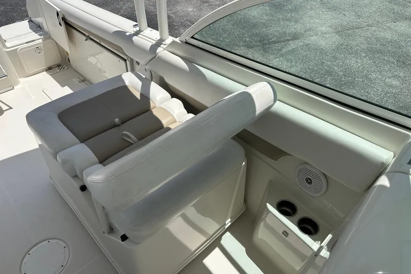 Slide: The Image of Interior of a 2015 Sailfish 275 DC boat featuring comfortable seating and cup holders. - 20