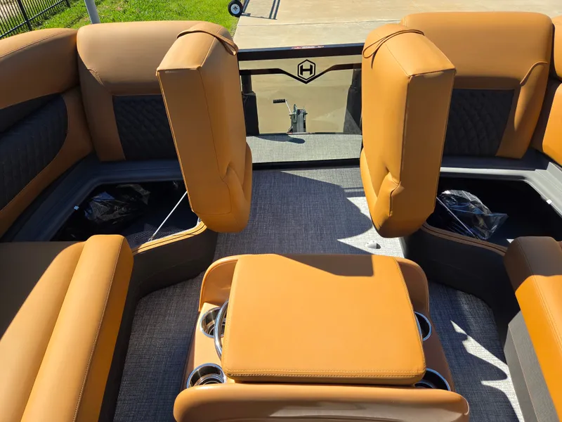 Slide: The Image of The image shows the interior of a 2027 Harris Sunliner 230 with beige upholstery and cup holders. - 13