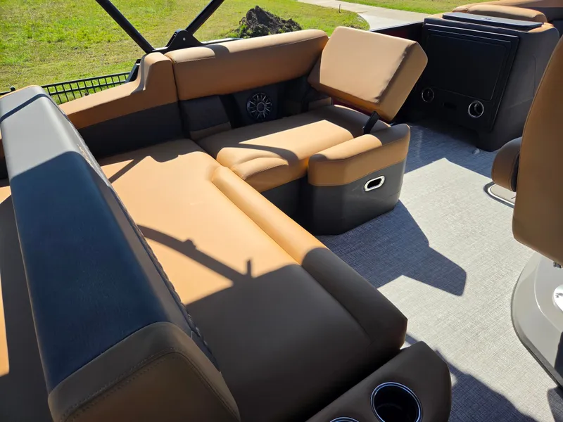 Slide: The Image of The image shows the seating area of a 2027 Harris Sunliner 230 with brown upholstery. - 23