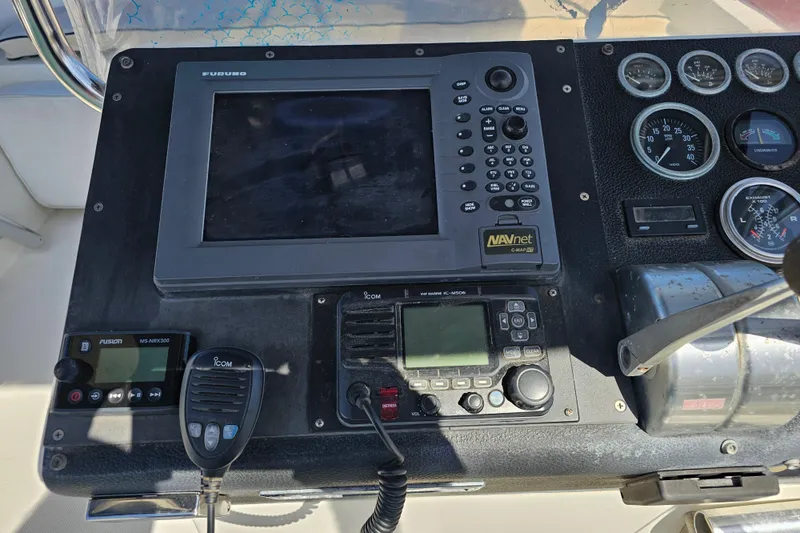 Slide: The Image of Control panel of a 1990 Mediterranean 38 Convertible boat with navigation and communication equipment. - 13
