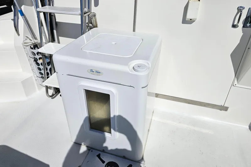 Slide: The Image of White deck area on a 1990 Mediterranean 38 Convertible boat with storage compartment. - 14