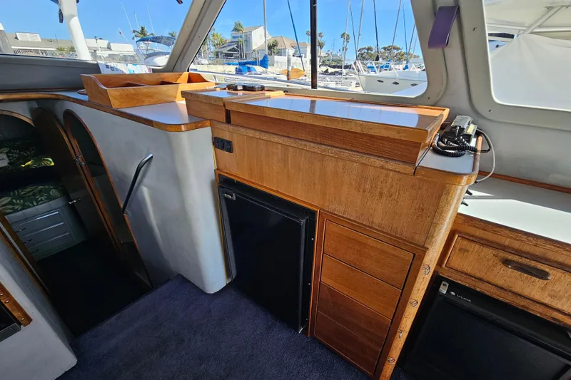 Slide: The Image of Interior of a 1990 Mediterranean 38 Convertible yacht with wooden cabinetry and modern amenities. - 16
