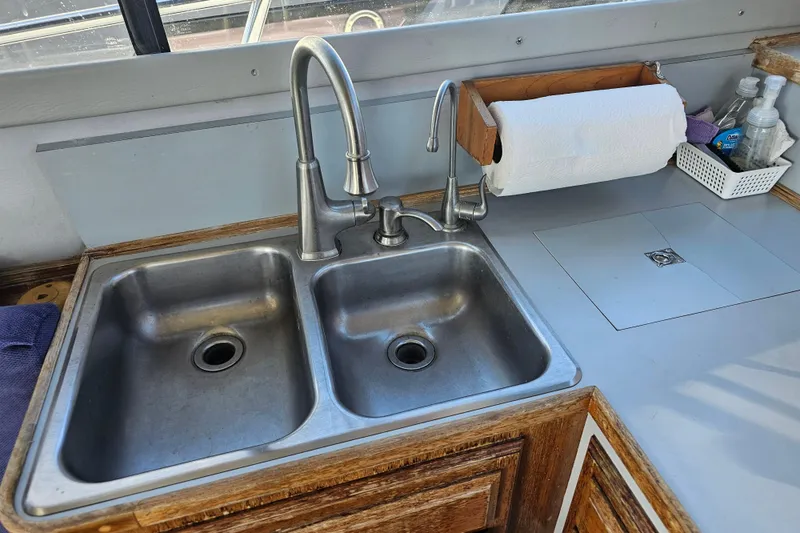 Slide: The Image of Stainless steel double sink in 1990 Mediterranean 38 Convertible boat kitchen. - 18