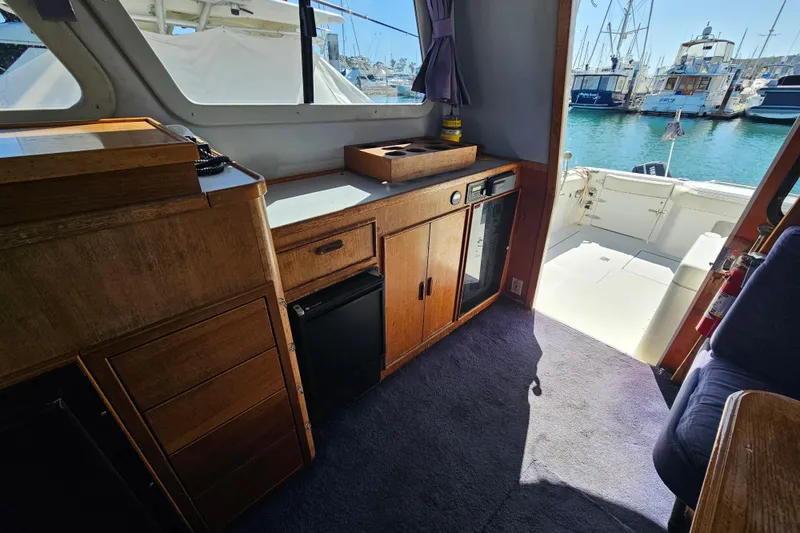 Slide: The Image of Interior of 1990 Mediterranean 38 Convertible yacht with wooden cabinetry and marina view. - 19