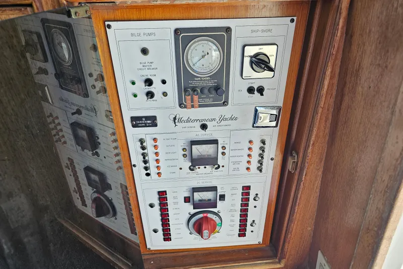 Slide: The Image of Control panel of a 1990 Mediterranean 38 Convertible yacht with various switches and gauges. - 22