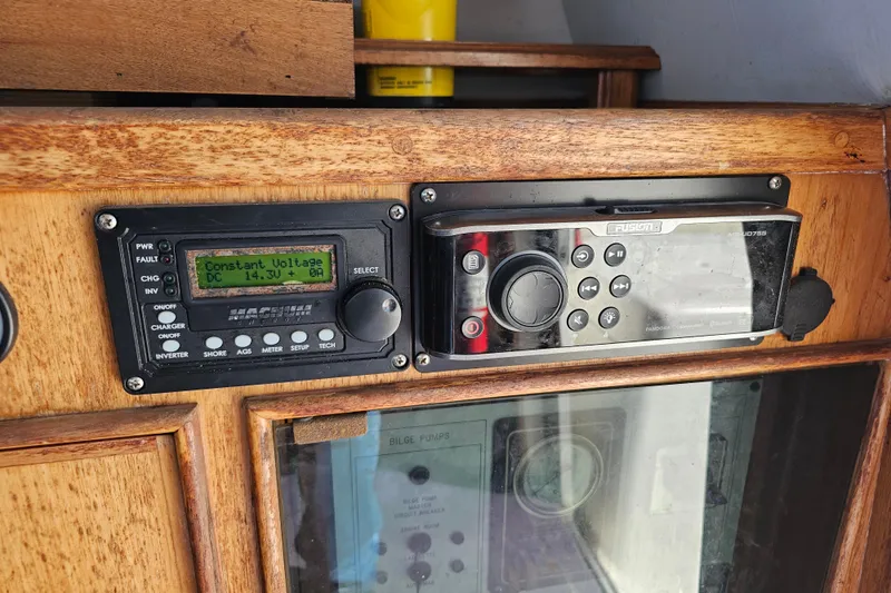 Slide: The Image of Control panel on a 1990 Mediterranean 38 Convertible boat, featuring voltage display and audio system. - 23