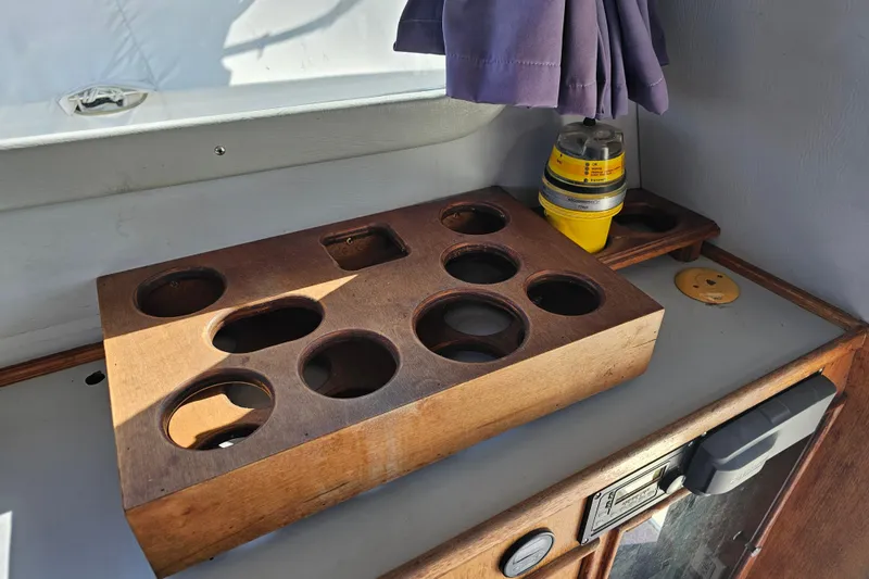 Slide: The Image of Wooden cup holder and safety equipment on 1990 Mediterranean 38 Convertible boat. - 24
