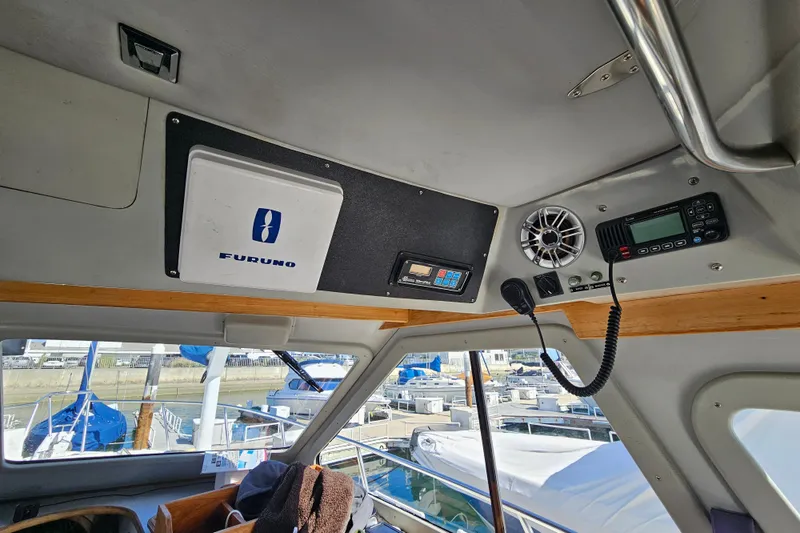 Slide: The Image of Interior view of a 1990 Mediterranean 38 Convertible boat with navigation equipment. - 26