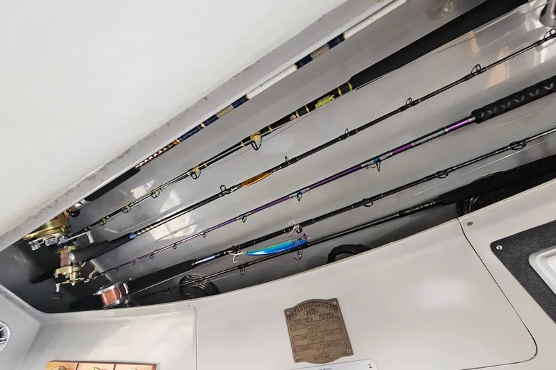 Slide: The Image of Fishing rods stored on a 1990 Mediterranean 38 Convertible boat interior. - 27
