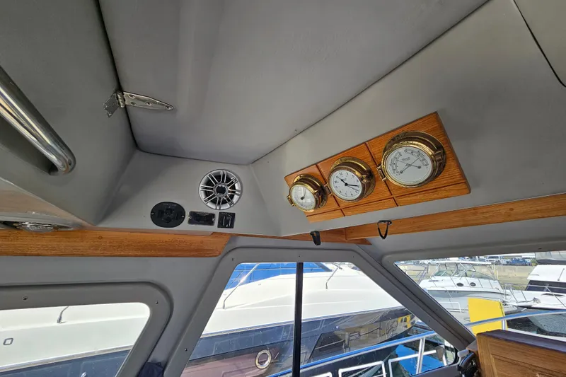Slide: The Image of Interior of 1990 Mediterranean 38 Convertible boat with gauges and speaker. - 28