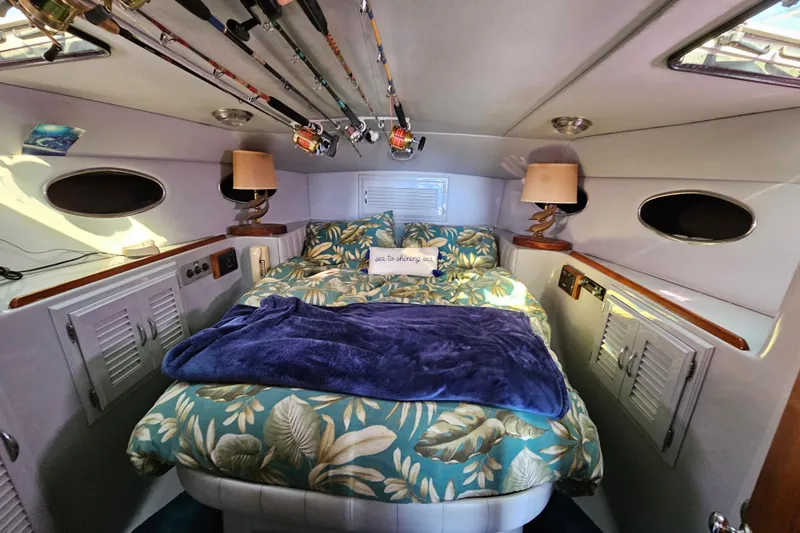 Slide: The Image of Luxurious cabin interior of a 1990 Mediterranean 38 Convertible yacht with fishing rods. - 29
