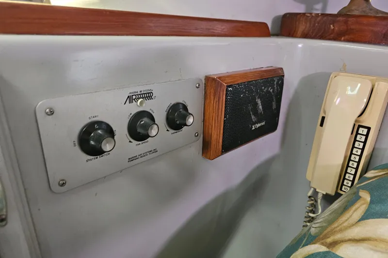 Slide: The Image of Control panel and phone on 1990 Mediterranean 38 Convertible boat interior. - 32