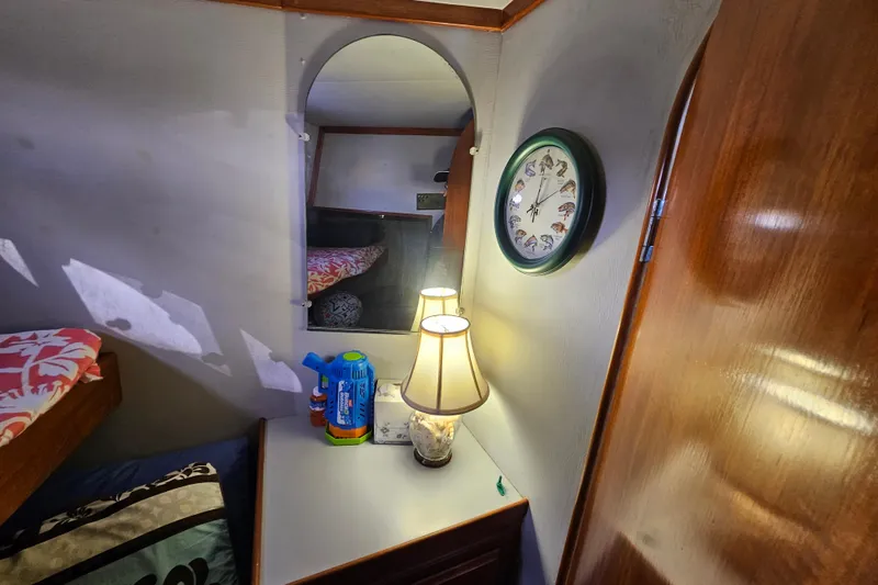 Slide: The Image of Cozy cabin interior of 1990 Mediterranean 38 Convertible with lamp and wall clock. - 33