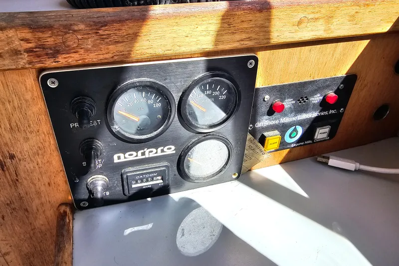 Slide: The Image of Control panel of a 1990 Mediterranean 38 Convertible boat with gauges and switches. - 38