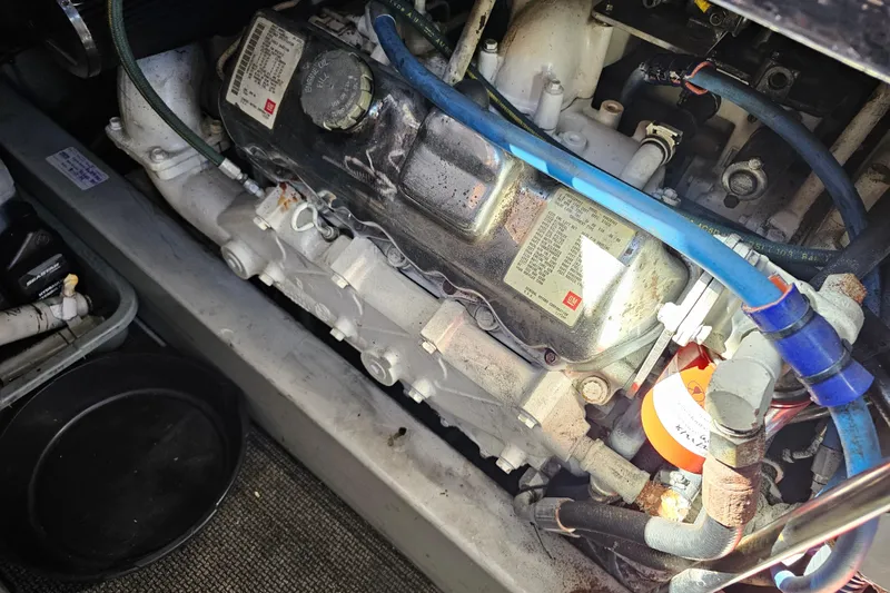 Slide: The Image of Engine compartment of a 1990 Mediterranean 38 Convertible boat, featuring visible hoses and components. - 39