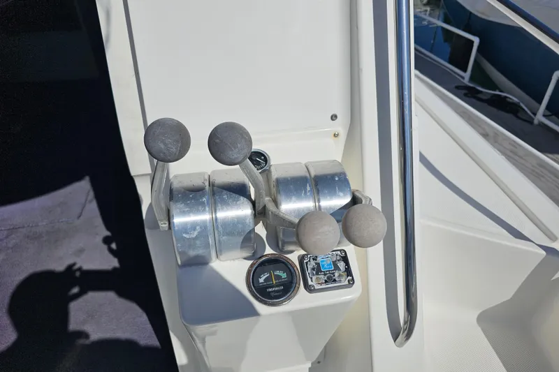 Slide: The Image of Control panel of a 1990 Mediterranean 38 Convertible boat with throttle levers and gauges. - 4